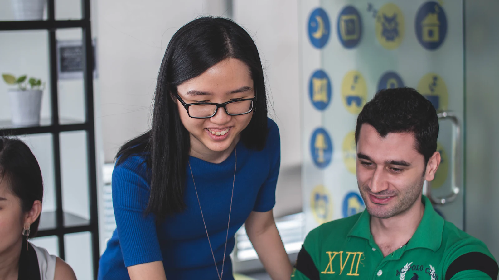 Filipino virtual assistant wearing a headset smiling during a video call in a bright home office