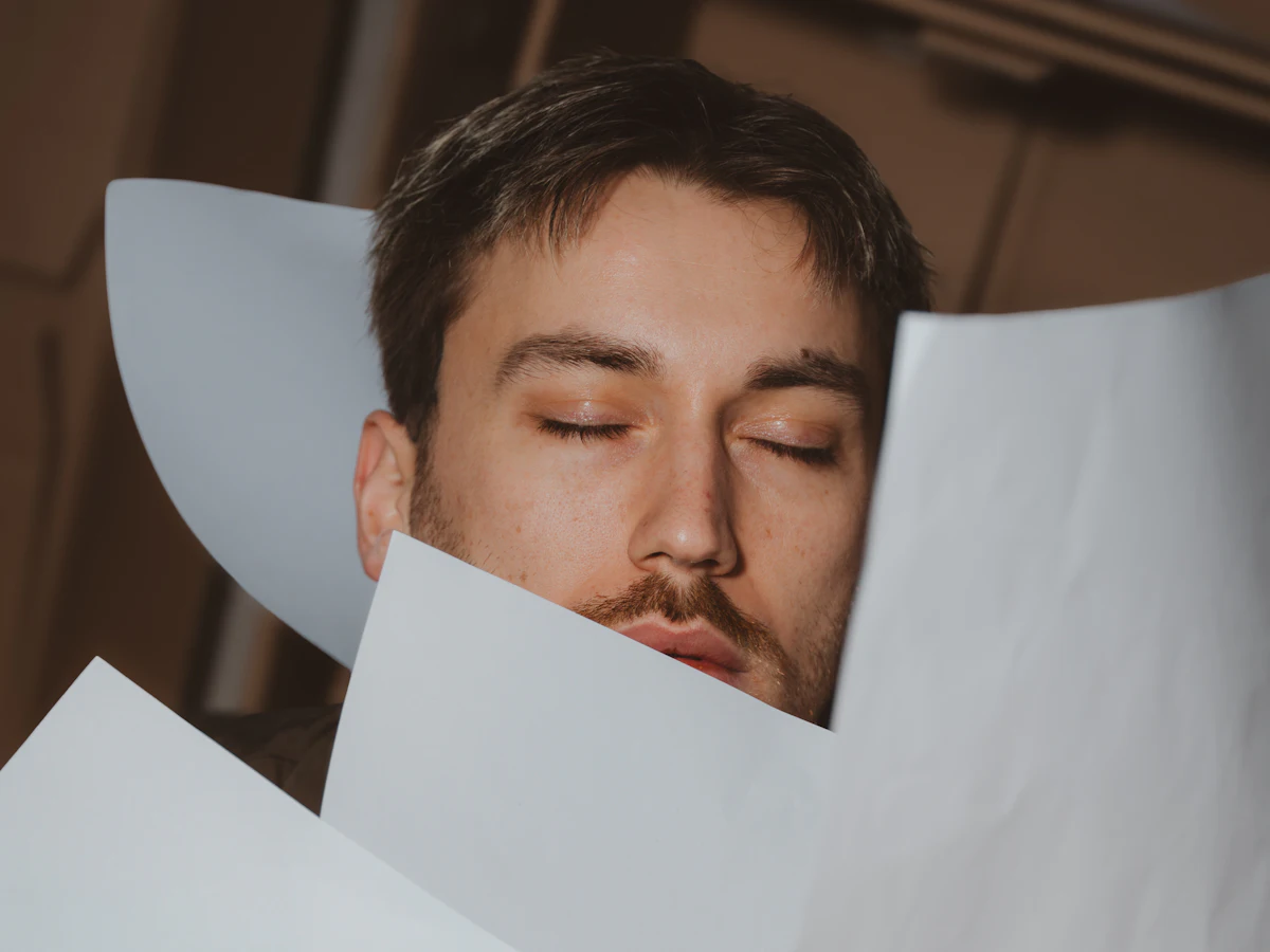 Business owner overwhelmed by paperwork and emails at a desk